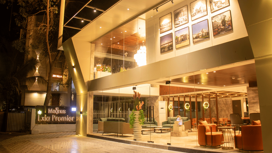 The exterior of a hotel with lit facade and entrance area at Magnus Lxia Premier, Kalyani Nagar.