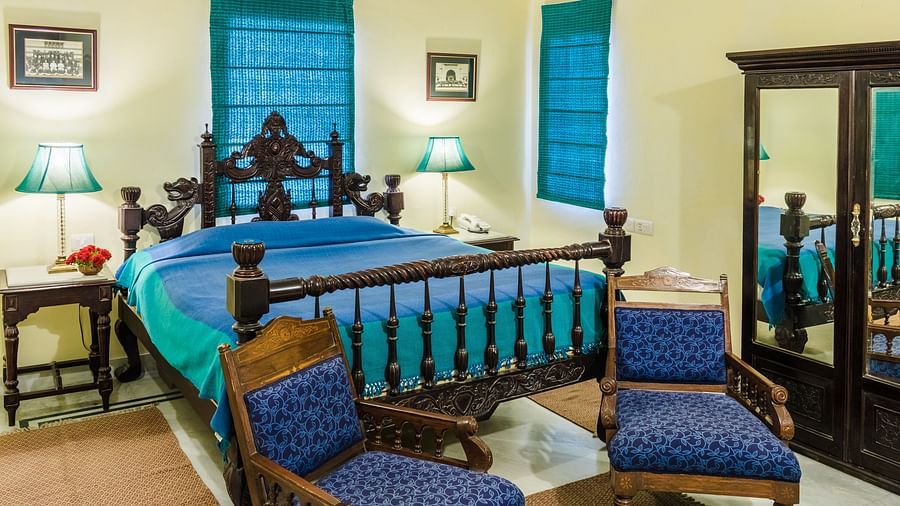 A kind bed with side tables and lamps on it inside Standard rooms - Mandawa Haveli, Jaipur