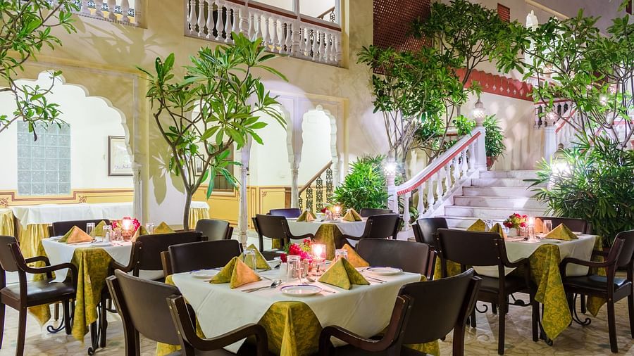 Outdoor seating next to potted plants at Hari Mahal - Mandawa Haveli, Jaipur