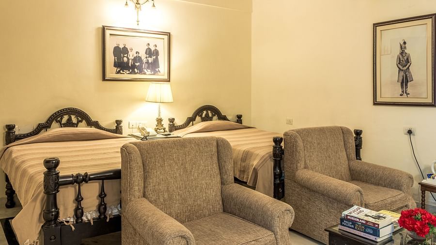 Twin beds with single seater sofas in front of the beds inside Standard rooms - Mandawa Haveli, Jaipur