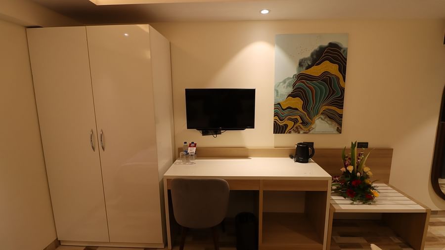 Cupboard and TV with desk at the side of the Superior Twin room - Mastiff Hotel, Dhanbad