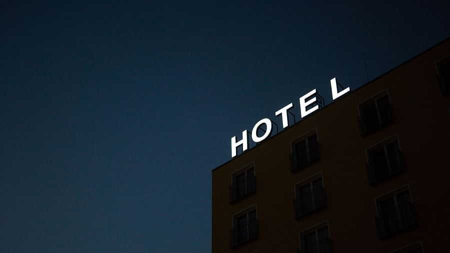 Facade of a hotel in the evening with the signage Hotel on the top of the building