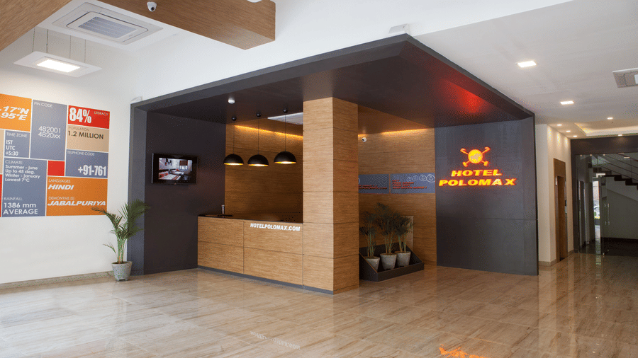 An image of a reception lobby featuring a reception desk , and a seating area for the guest - Max Hotel Jabalpur