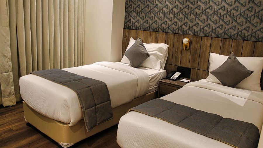 Twin beds in hotel with white and grey bedding at Maxxvalue Hotel MIDC,  Mumbai
