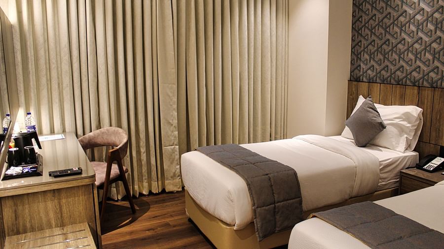 Twin beds in hotel with white and grey bedding at Maxxvalue Hotel MIDC,  Mumbai