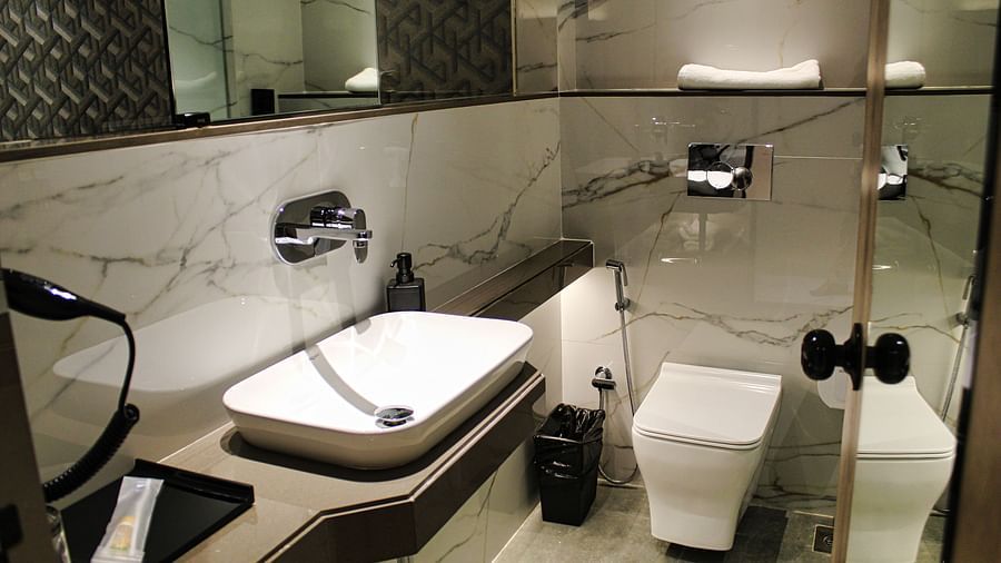 Bathroom with modern amenities at Maxxvalue Hotel MIDC,  Mumbai