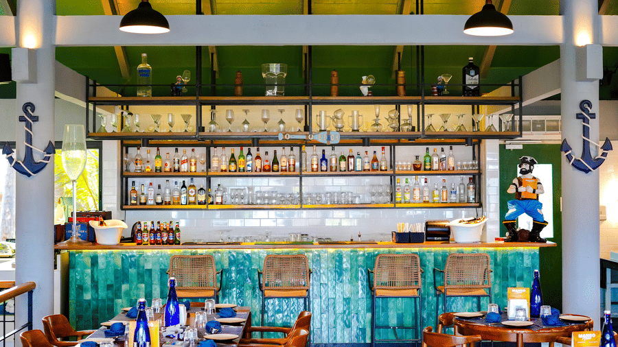 A Bar at MGM Beach Resorts, with chairs, bottles arranged on the bar shelf.