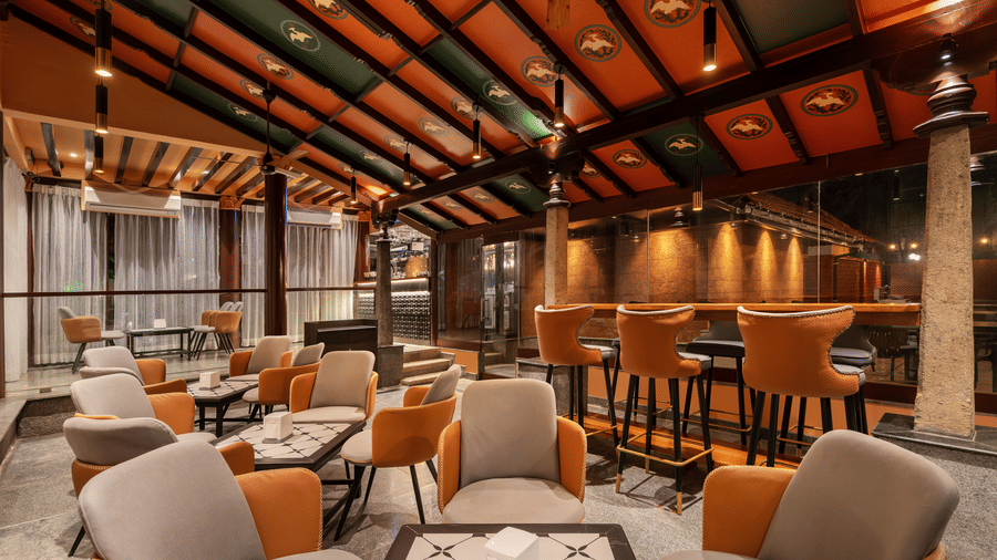 Cozy indoor lounge area at MGM Beach Resorts with cushioned seating, warm lighting, and contemporary wooden decor.