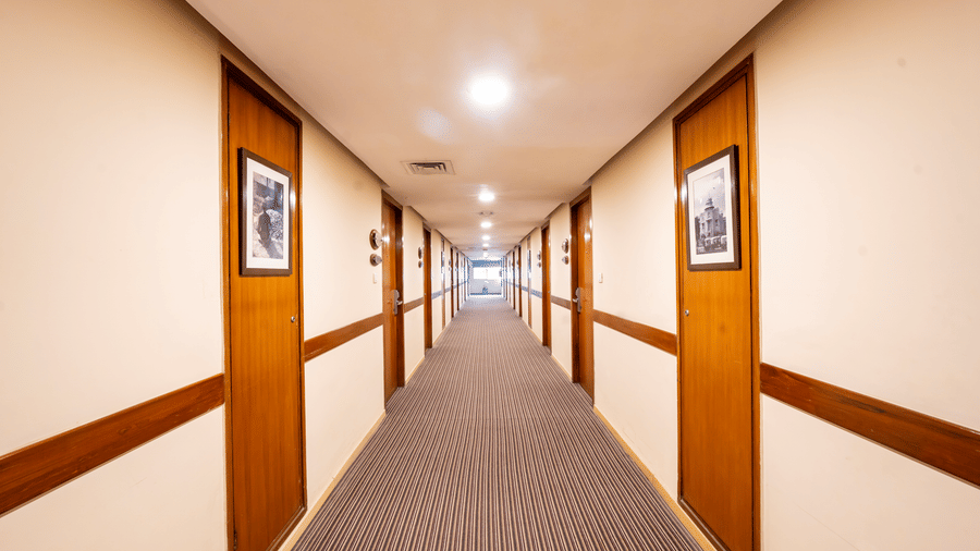 A corridor with several doors and wall arts. | MGM Mark Whitefield