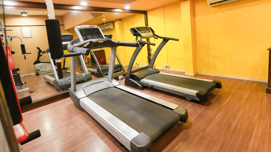 A fitness centre with treadmills, mirrors and other gym equipments placed in a closed space. | MGM Mark Whitefield