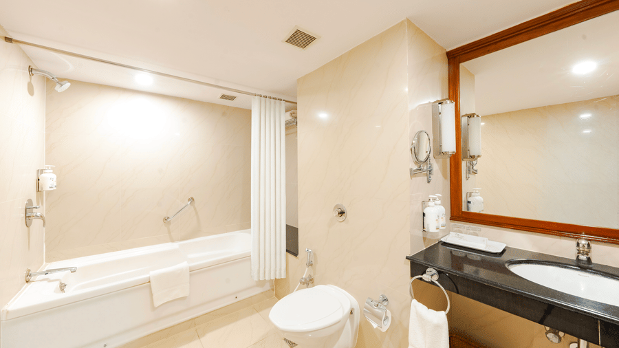 MGM Mark Whitefield |  A bathroom with a toilet seat, a mirror, and a bathtub.