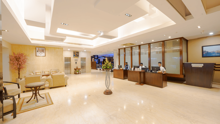 The reception at MGM Mark Whitefield, with sofas, elongated desk, and lights.