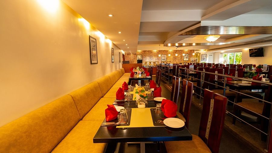 Image of restaurant featuring buffet counter with food under warm ambience