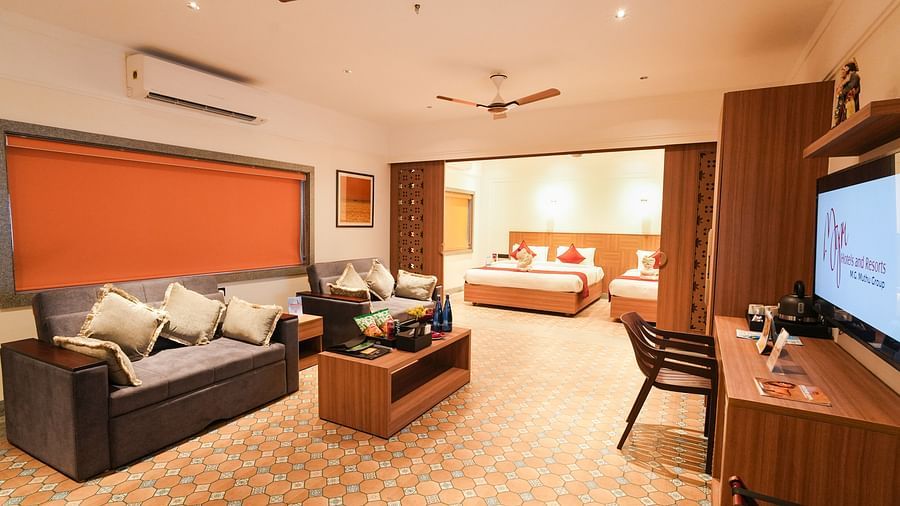 Image featuring a partition between the living room and bedroom featuring sofa-cum-beds in living room and double bed and a single bed in the bedroom