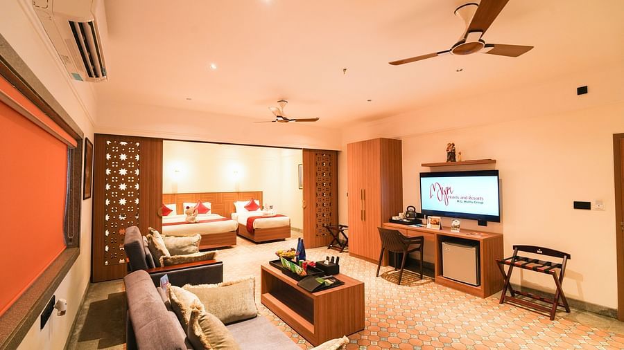 Image of Mary View Suite featuring a section parting bedroom from the living room while the bedroom has a double bed and a single bed and the living room has two sofa-cum-beds