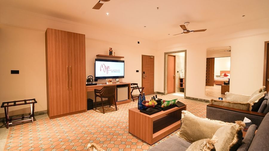 Image of living room of Mary View Suite featuring the sofa-cum-bed with a coffee table facing the TV 