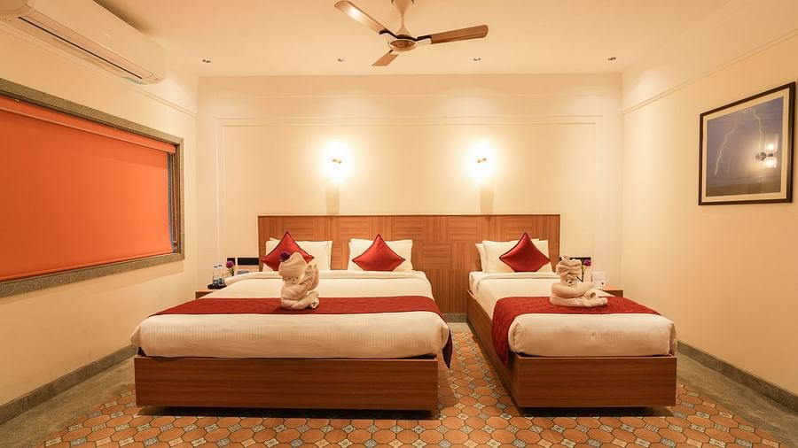 Image of Mary View Suite featuring a double bed next to a single bed in warm lighting
