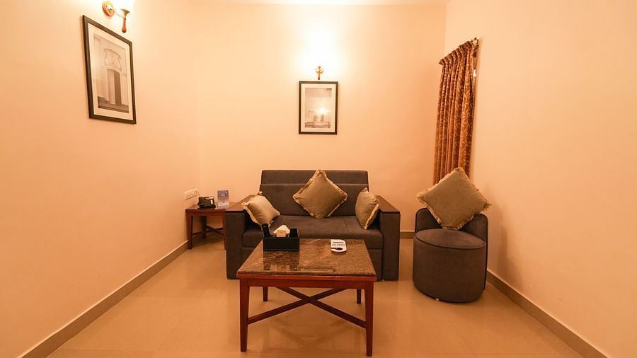 Image of Grandeur Pool View Suite featuring a sofa set and a coffee table placed in front of it