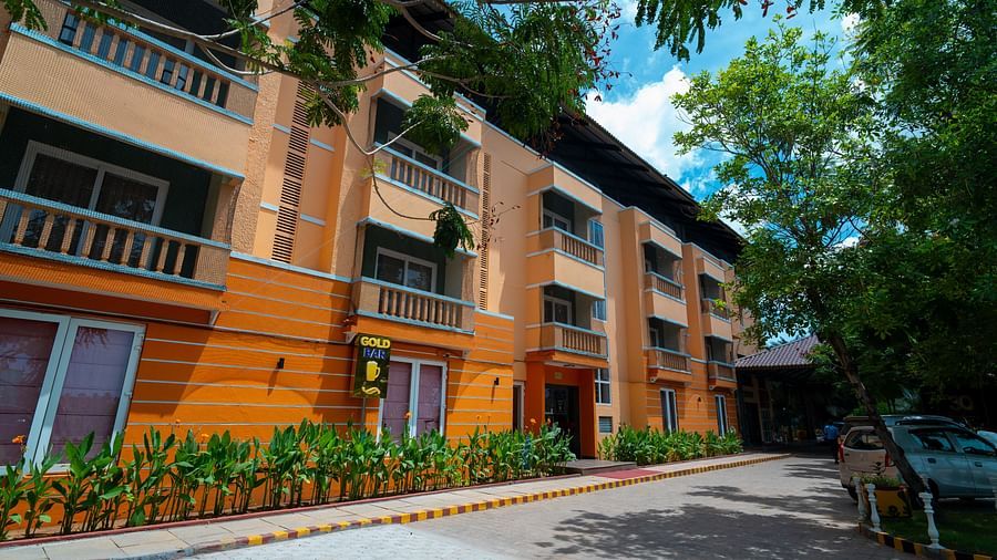 Pavements of MGM Vailankanni Residency right next to the building where bar is mentioned with trees and plants on both sides