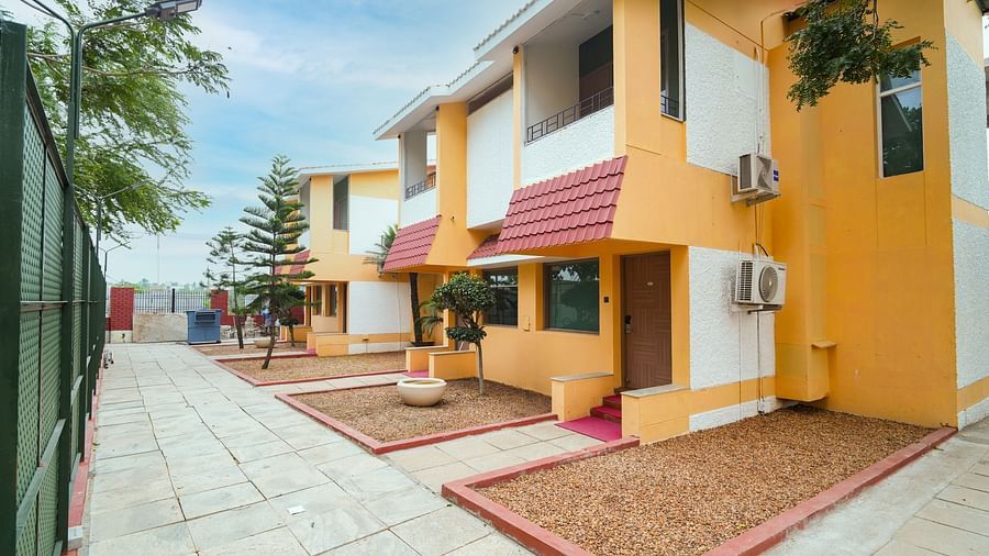 Image of two-story buildings with pavements leading to each of them