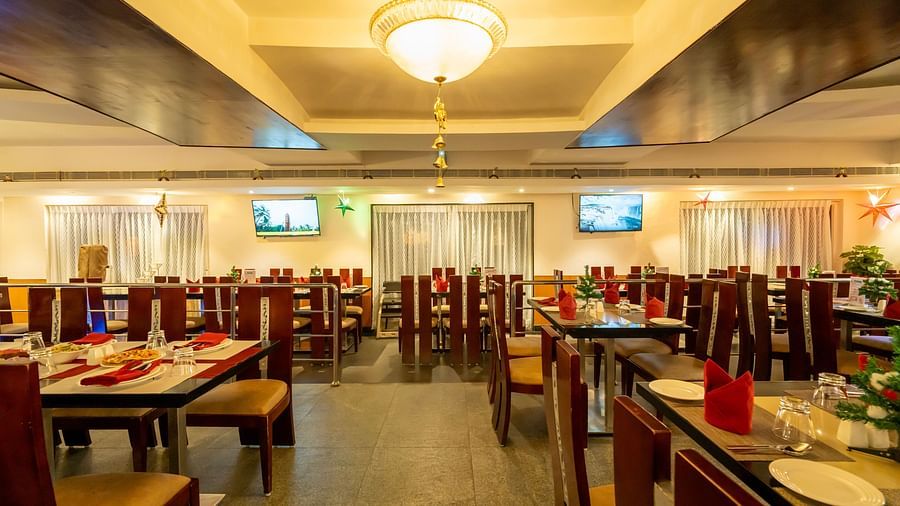 A warm-lit restaurant boasting a cosy ambience with sitting arrangements with chairs and tables