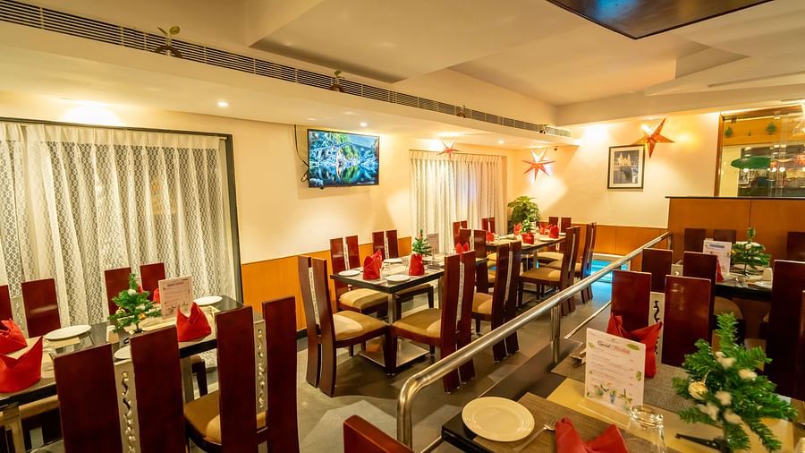 Image of a warm-lit restaurant with tables and chairs arranged