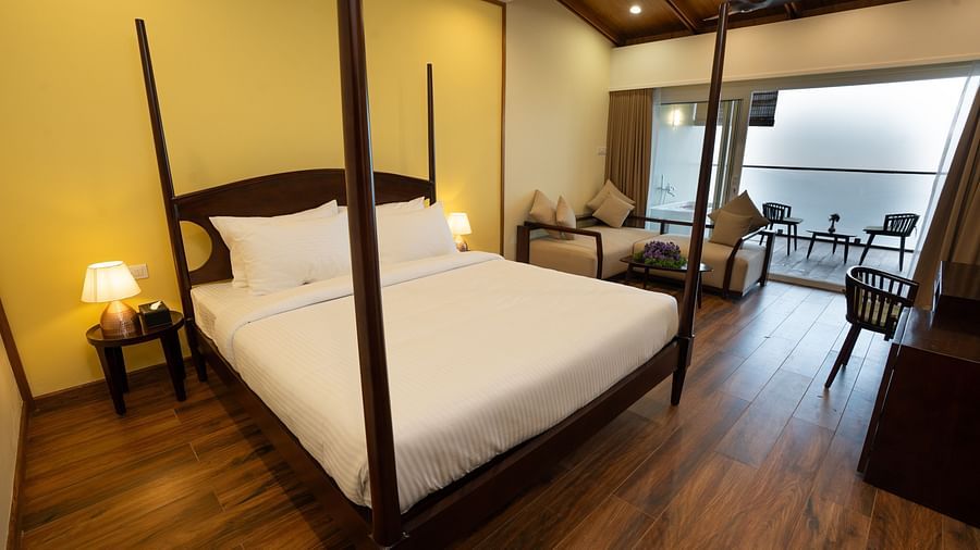 A bed in a room with a mountain view | Misty Queen by Dimora, Kakkadampoyil