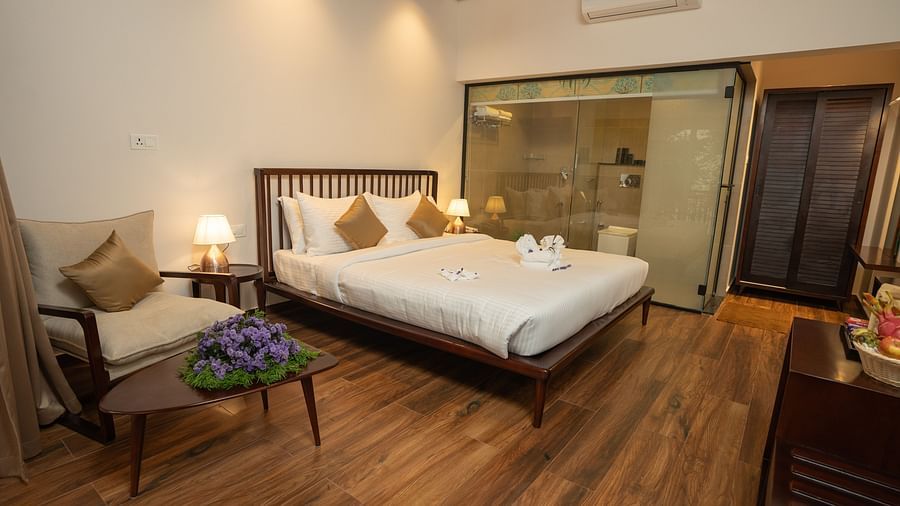 A full view of a room with bed and a sofa chair | Misty Queen by Dimora