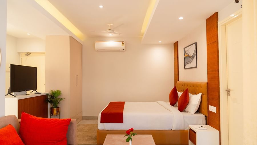 A large bed facing the television in a Standard Room at Montclair Ananta, Elite.