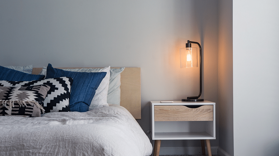 room with a bed and bedside lamp