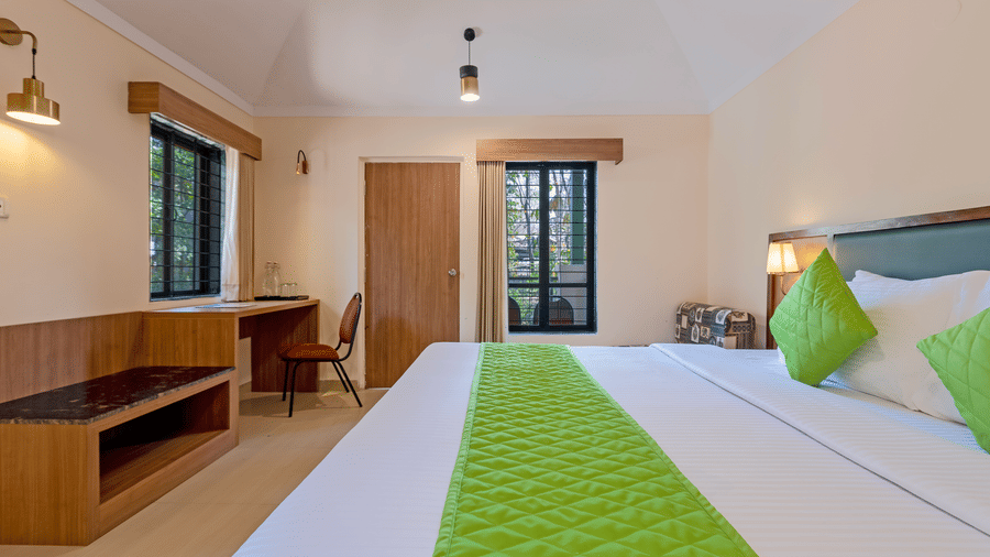 Classic room bedroom with a double bed, green runner, work desk, and window for natural light.