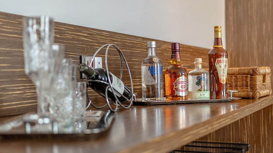 A kitchenette with beverages and glassware at Neelkanth Sarovar Premiere Lusaka