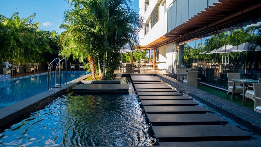 A relaxing poolside deck with comfortable seating at Neelkanth Sarovar Premiere Lusaka