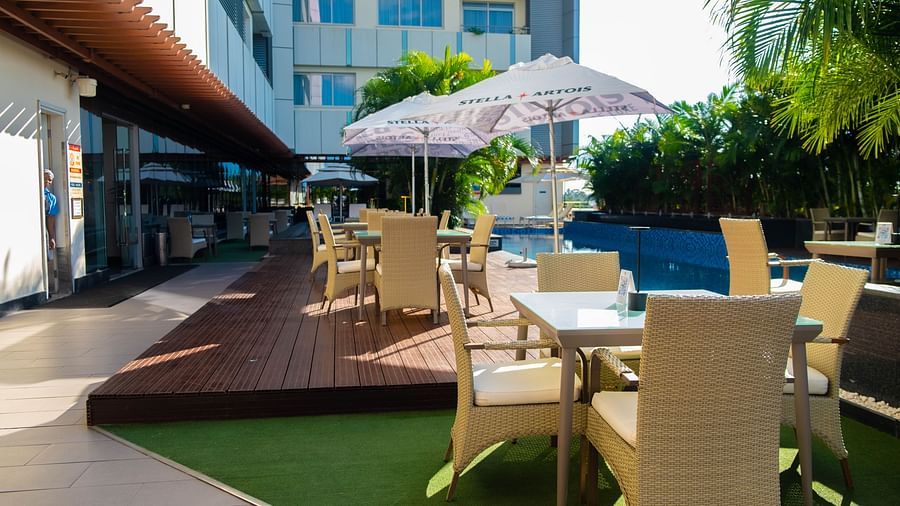 A stylish outdoor seating area at Swirl Bar Deck at Neelkanth Sarovar Premiere Lusaka