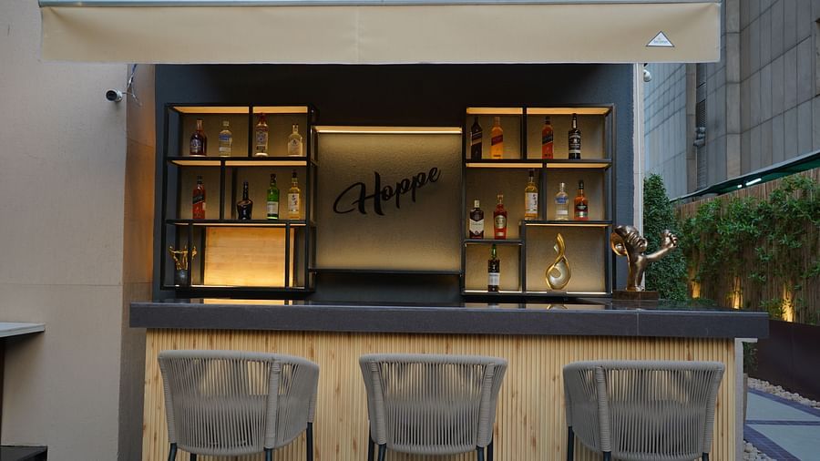 Nemesia features an outdoor bar area with shelves, a counter, and stools.