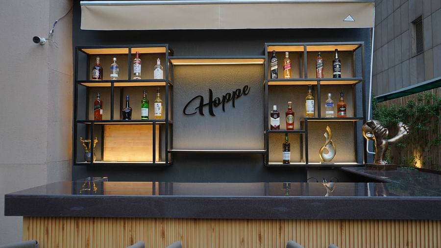 Another view shows Nemesia's outdoor bar area with shelves, a counter, and stools.