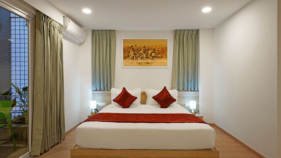 Studio King Room with cosy bed and wall painting at Nest by Rivido Apart Hotel, Bannerghatta Road