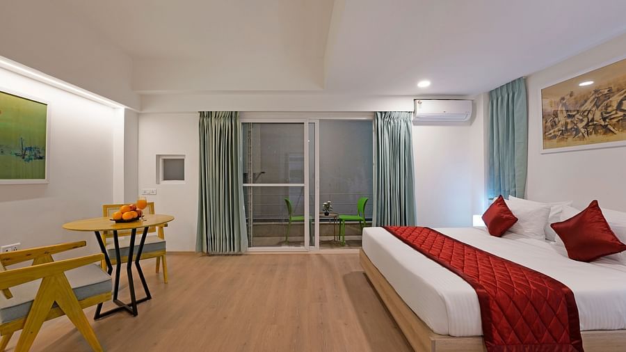 Side view of Studio King Room with bed and balcony access at Nest by Rivido Apart Hotel, Bannerghatta Road