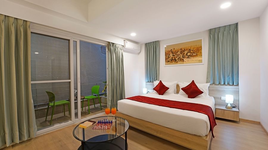 Side view of Studio King Room with bed and balcony access at Nest by Rivido Apart Hotel, Bannerghatta Road