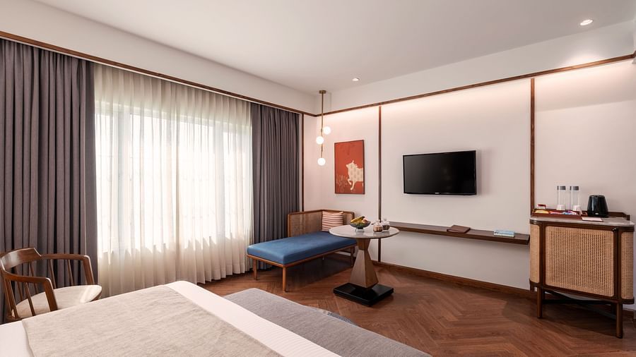 A modern hotel bedroom with a comfortable bed and a TV.
