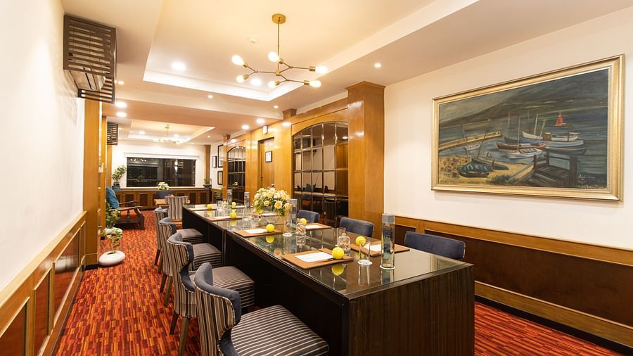 Captain's Cabin- Elegant bar lounge with red carpet, seating, and framed artwork in  Polo Floatel Kolkata