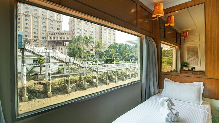 a bed beside the window  - polo floatel kolkata