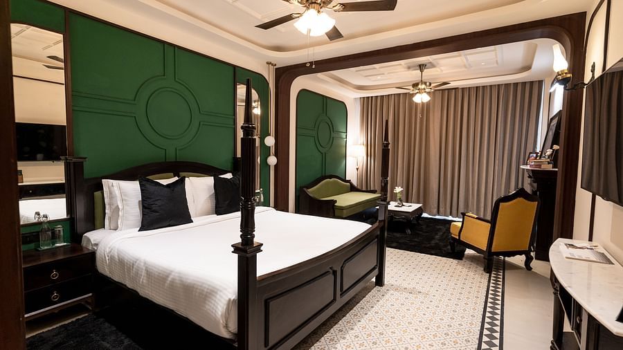 An image of a bedroom with king size bed, flat TV screen, chair, and sofa - Polo Orchid Resort, Cherrapunjee