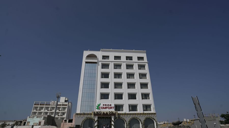 Facade of Pride Comfort, Dwarka on a clear blue day