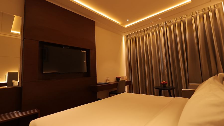 view of the king size bed of Deluxe Room at Pride Elite, Haridwar