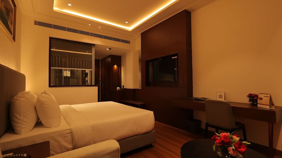 view of the king size bed of Deluxe Room at Pride Elite, Haridwar