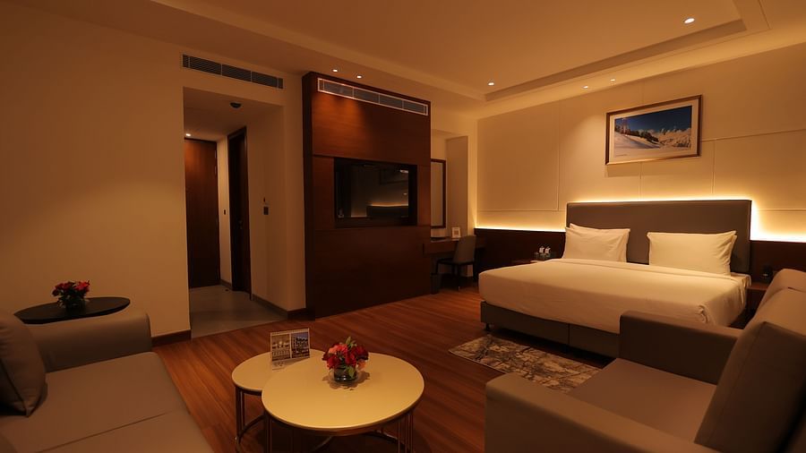 view of king size bed  and comfortable sofas of Premium Room at Pride Elite, Haridwar