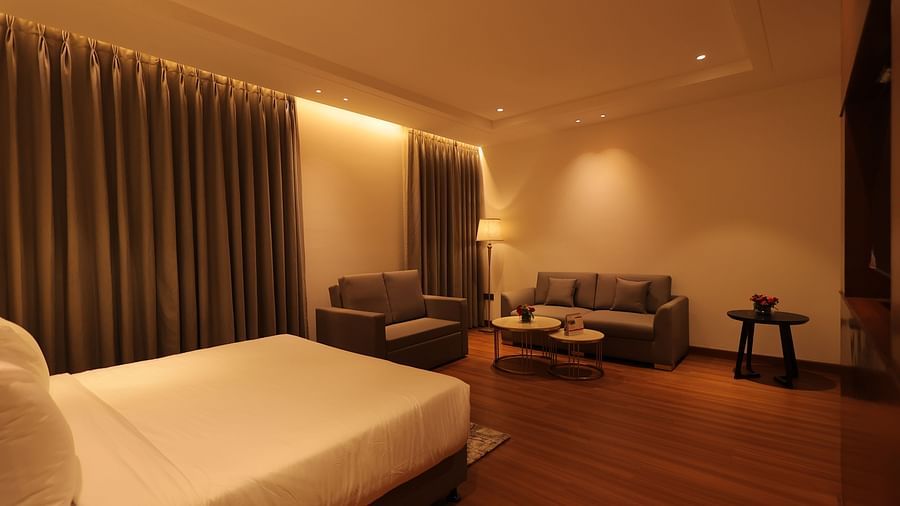 view of king size bed  and comfortable sofas of Premium Room at Pride Elite, Haridwar