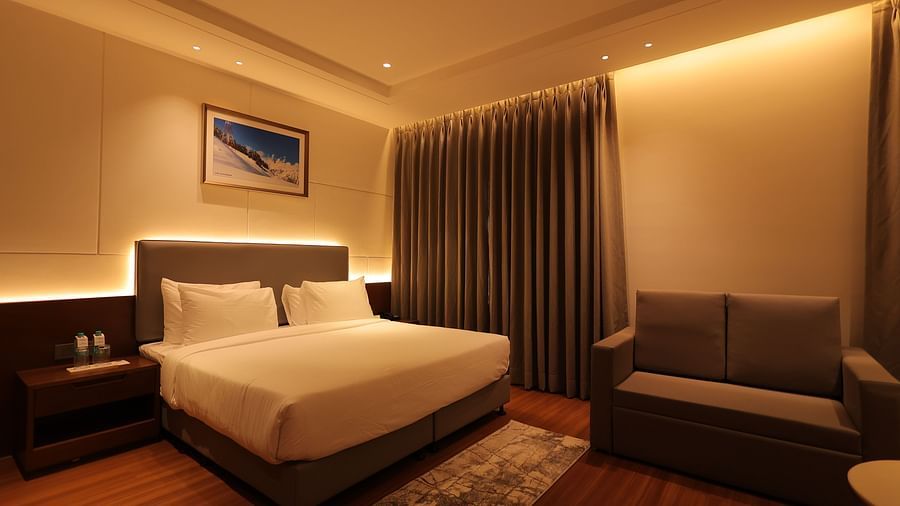 view of king size bed  and comfortable sofas of Premium Room at Pride Elite, Haridwar