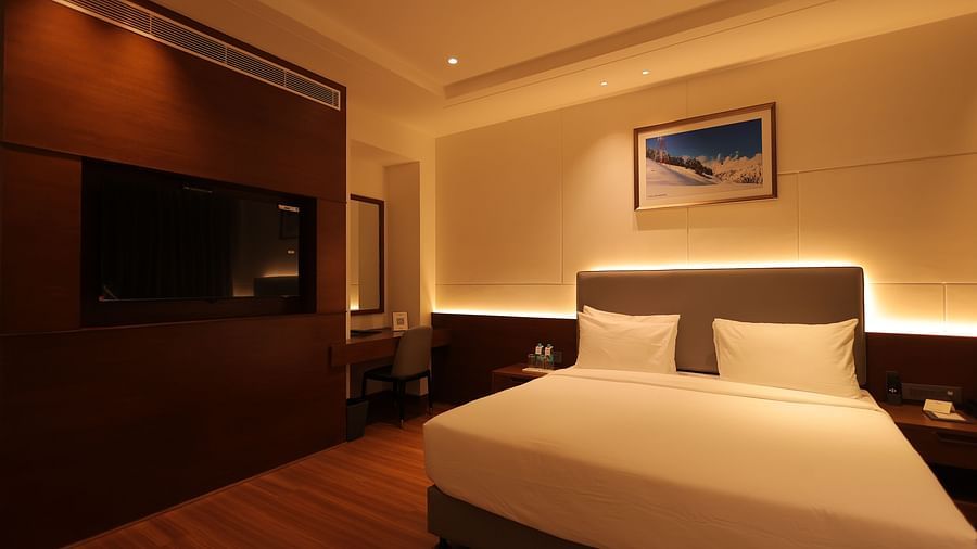 view of king size bed  and comfortable sofas of Premium Room at Pride Elite, Haridwar